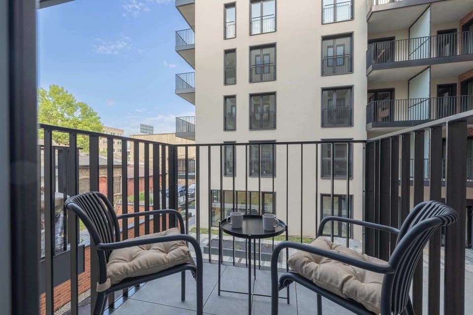 A private balcony furnished with comfortable outdoor seating. It's the perfect place to enjoy fresh air and your morning coffee.