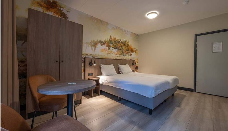 Drift off in a spacious double room with soft, warm lighting.