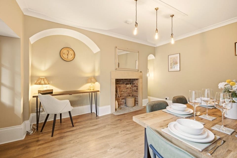 Dining area with feature fireplace and seating for family meals.
