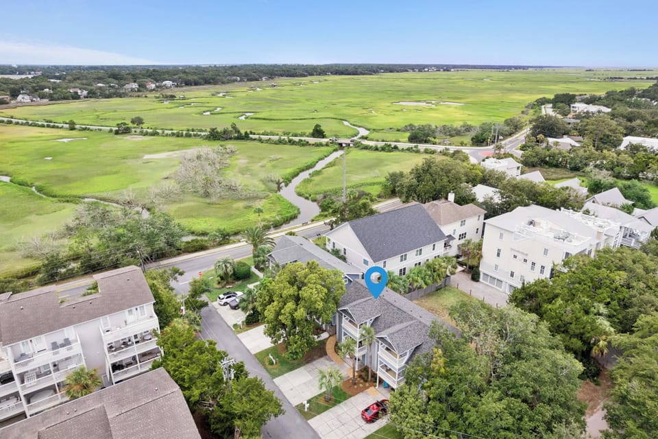 This charming property sits nestled in a peaceful coastal neighborhood, surrounded by lush green marshlands and just moments from nearby amenities.