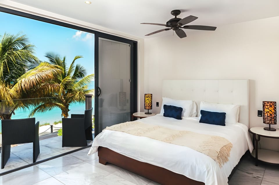 Sip morning coffee as palm-framed ocean views fill the room.