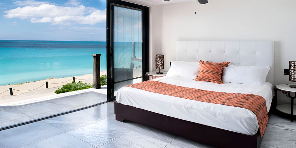 Wake up to panoramic sea views from a plush king bed.