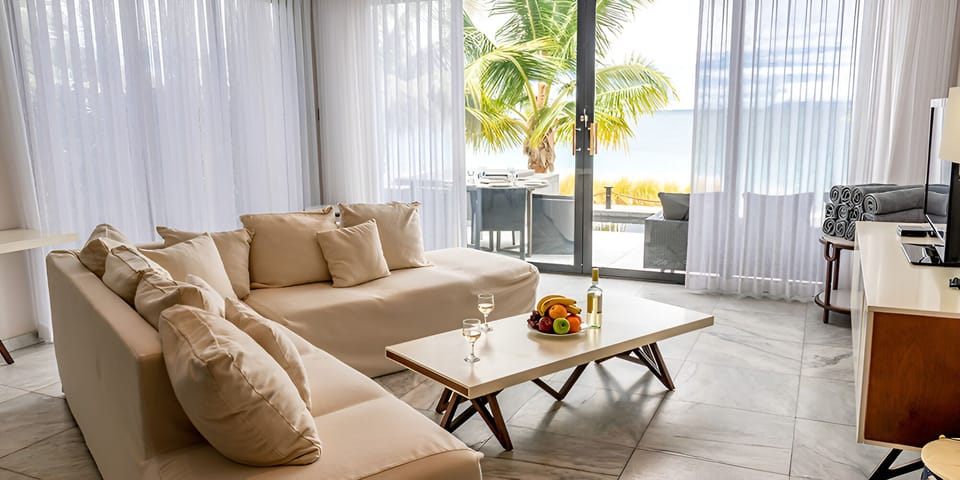 Lounge with sea breezes drifting through sunlit glass doors.
