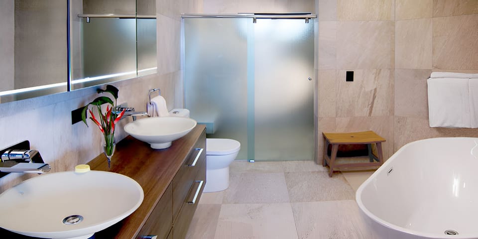 Refresh in a spa-like bath with soaking tub and glass shower.