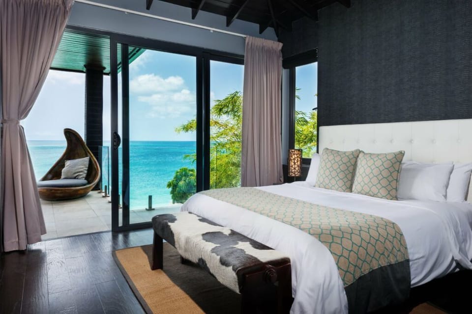 Drift off to ocean breezes beside floor-to-ceiling glass doors.