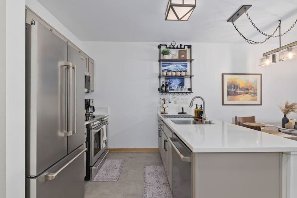 Sleek galley kitchen with dishwasher and ample counter space