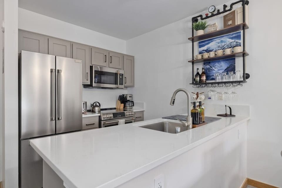 Full-size stainless fridge, gas range & microwave — everything you need to cook in