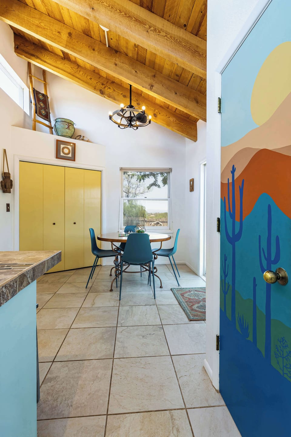 Sit down to breakfast beneath the chandelier and painted desert door