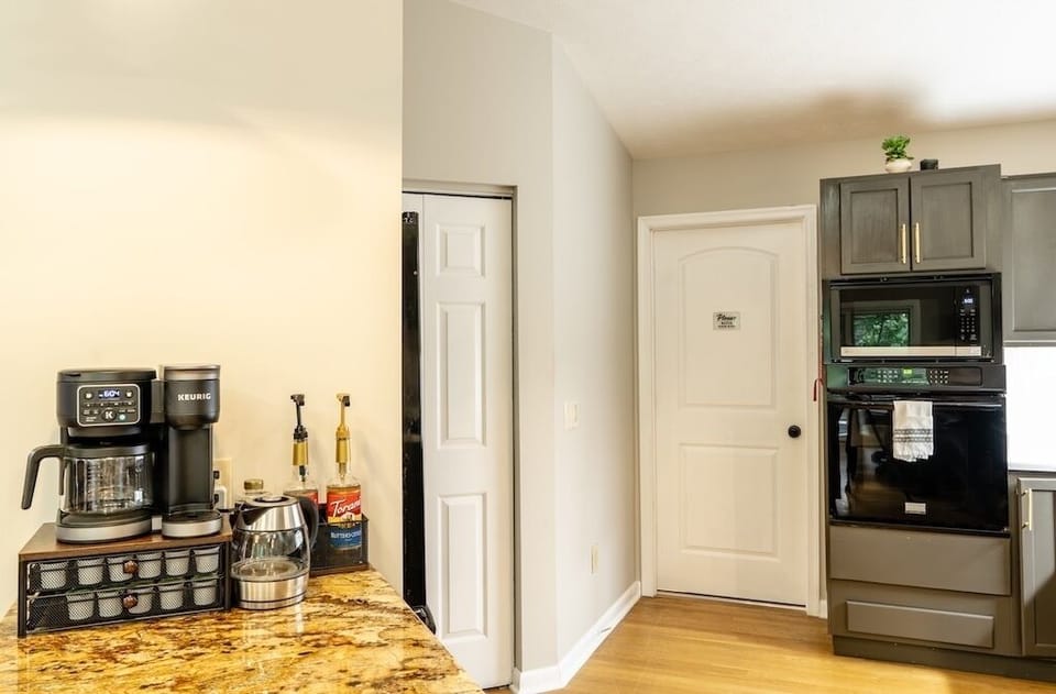 Bright kitchen with granite counters and a fully stocked coffee station