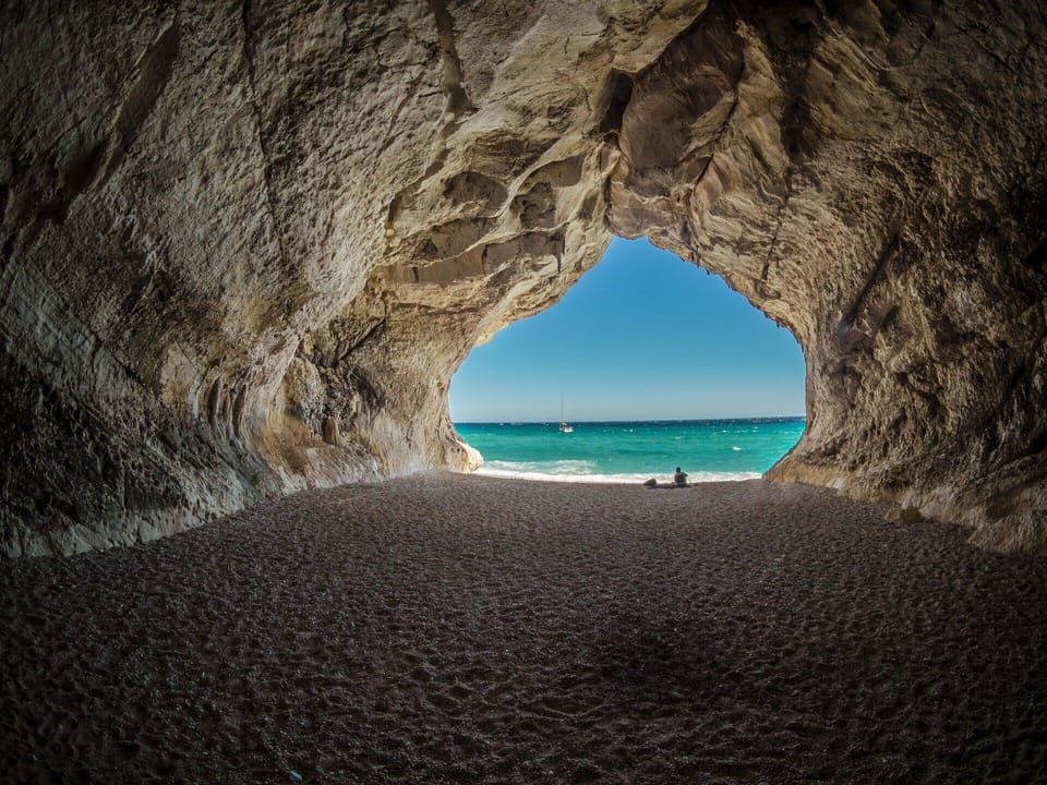 Secluded sea-cave beach with turquoise water—your ocean hideaway.