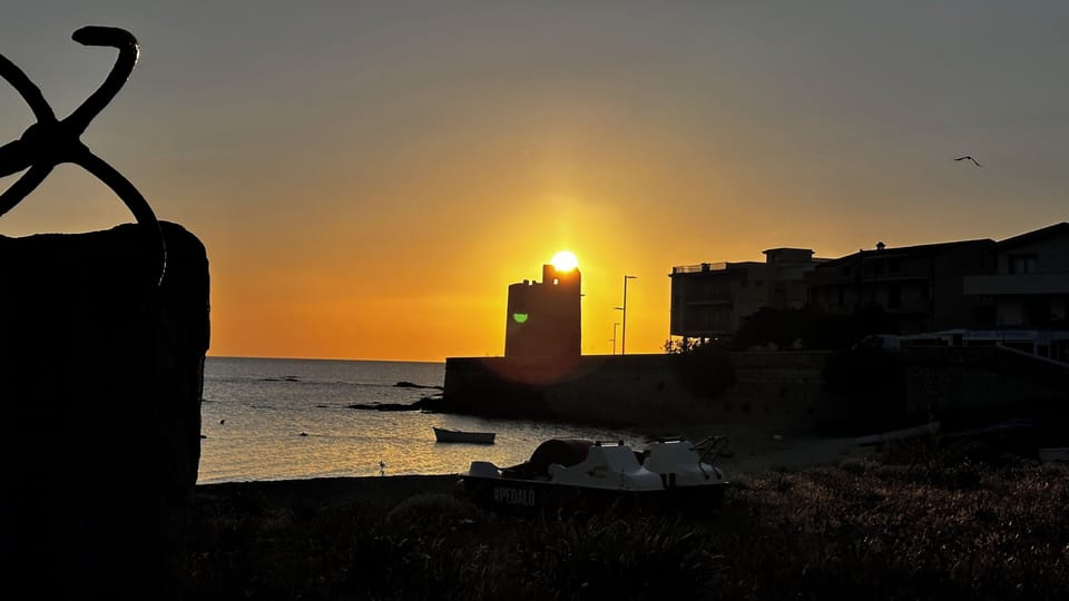 Golden sunset over the bay with tower views—steps to beach and calm waters.