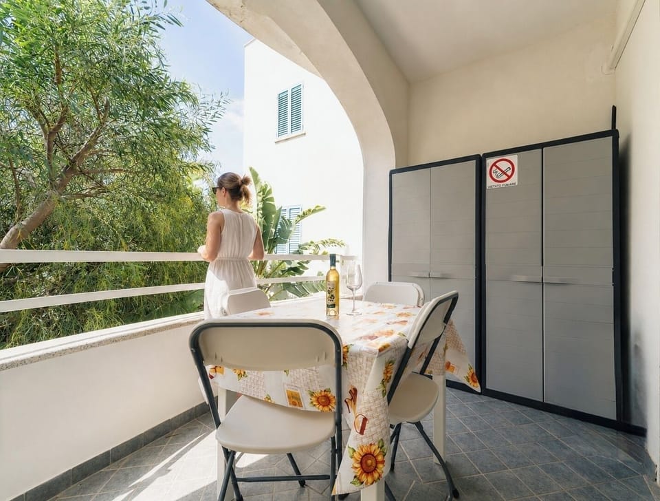 Covered balcony with outdoor dining and peaceful leafy views