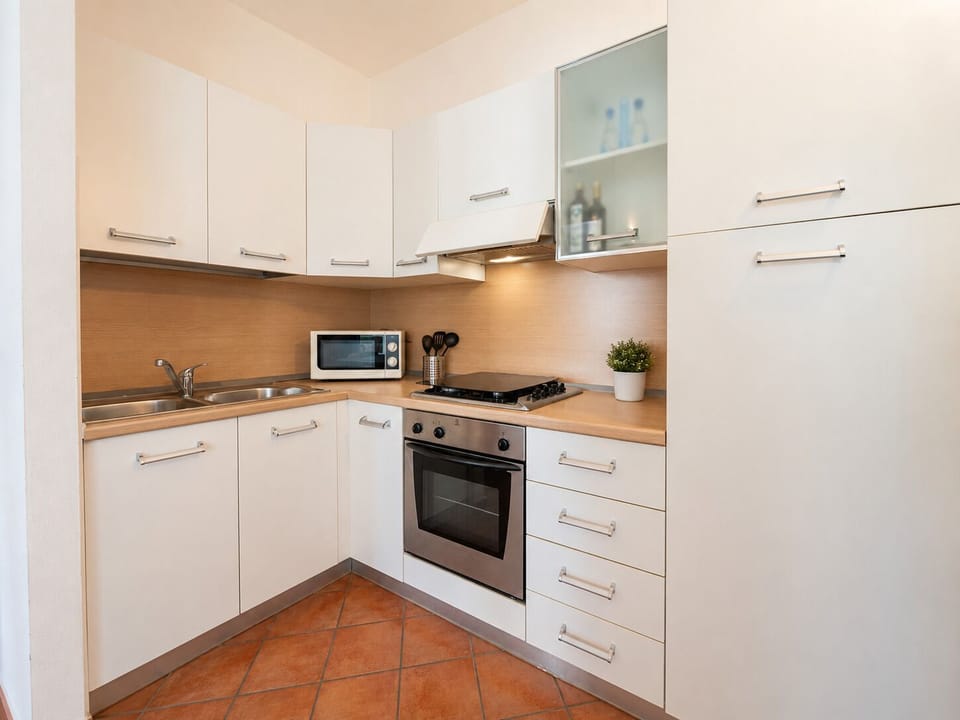 Bright, fully equipped kitchen with modern appliances and ample storage