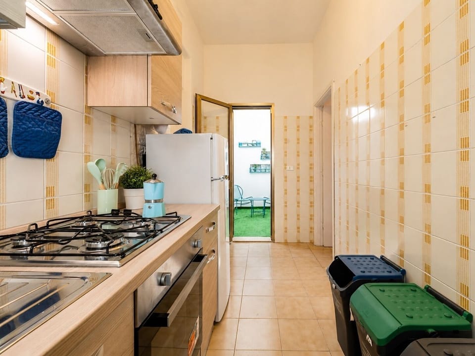 Bright galley kitchen with full appliances and access to outdoor space