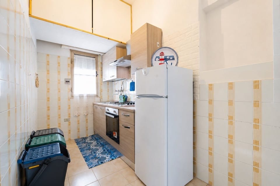 Bright, functional kitchen with full appliances and natural light
