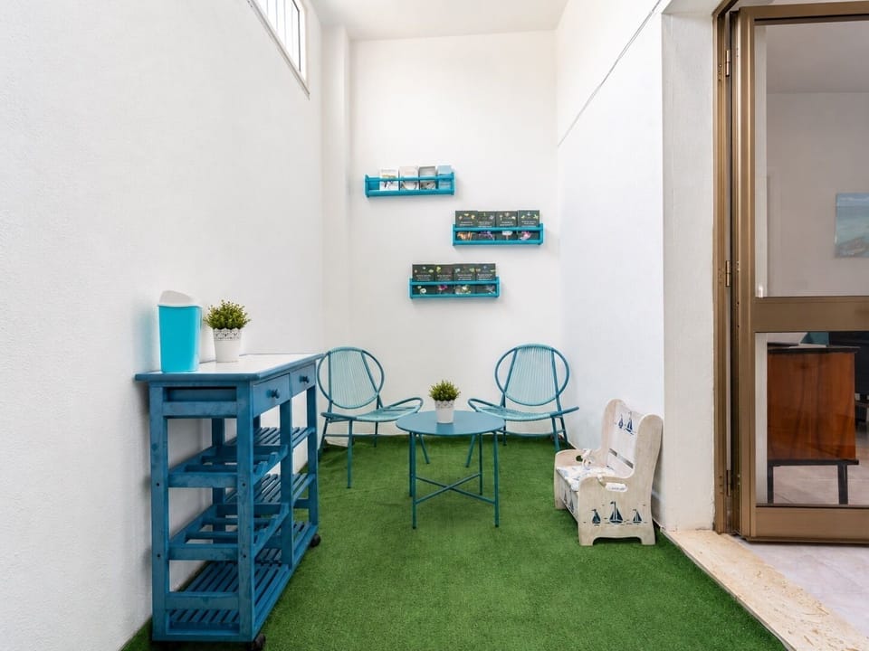Bright patio nook with cozy seating and cheerful blue accents