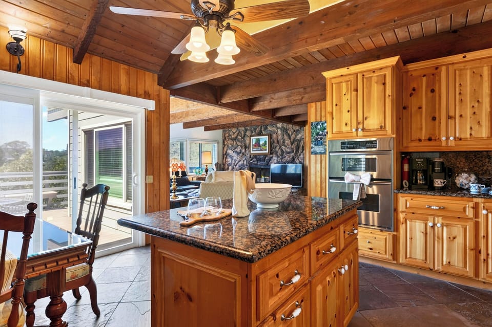 Kitchen island with wooden cabinets and bar stools.