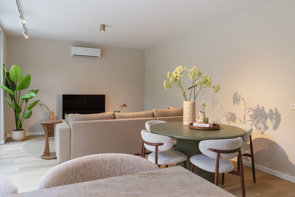 Bright modern lounge with cozy dining space and stylish neutral design