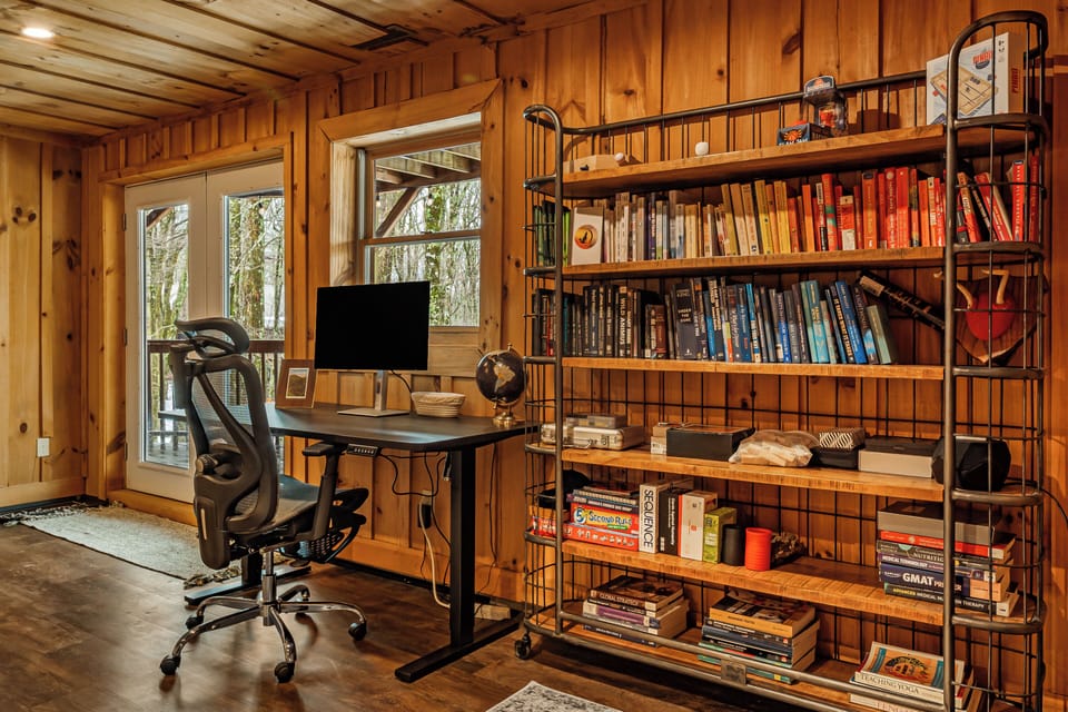 Perfect for work or play, the spacious lower level includes a dedicated desk, a library of books, and games for all to enjoy. 