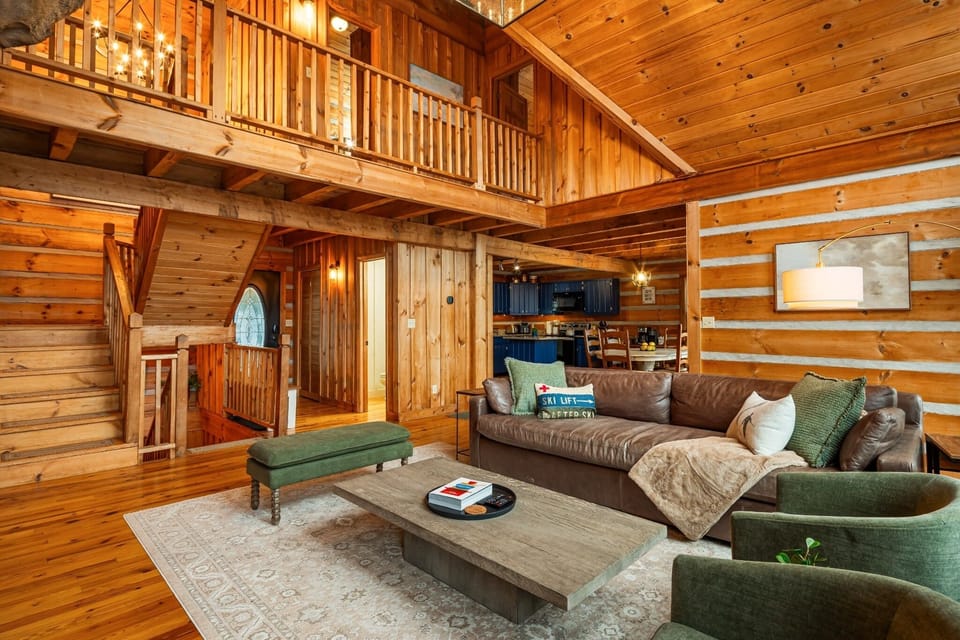 Gather in the heart of the cabin, where soaring ceilings, exposed timber beams, and open-concept living create the perfect mountain retreat.