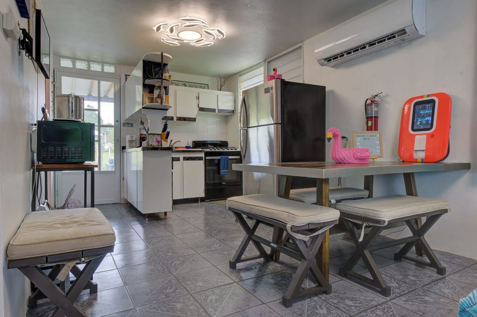 Cozy AC kitchen with stainless fridge, gas range and bench dining nook