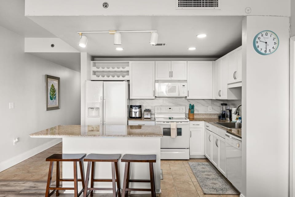 Your spacious kitchen is fully equipped with granite countertops, modern appliances, and plenty of storage. Whether you're making morning coffee or preparing a meal, you'll have everything you need in this bright, inviting space.