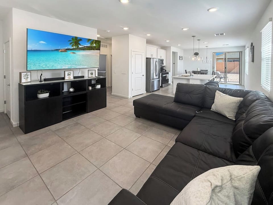 Living room with sectional sofa and wall-mounted TV