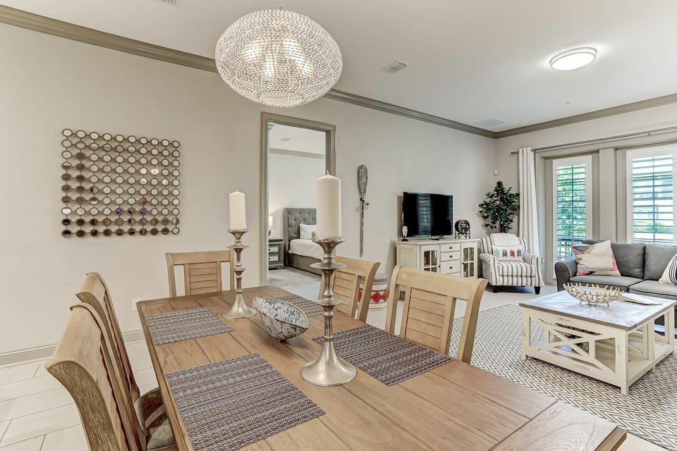 A bright, airy space where your dining area flows seamlessly into the living room, flooded with natural light and styled with warm coastal touches perfect for gathering.