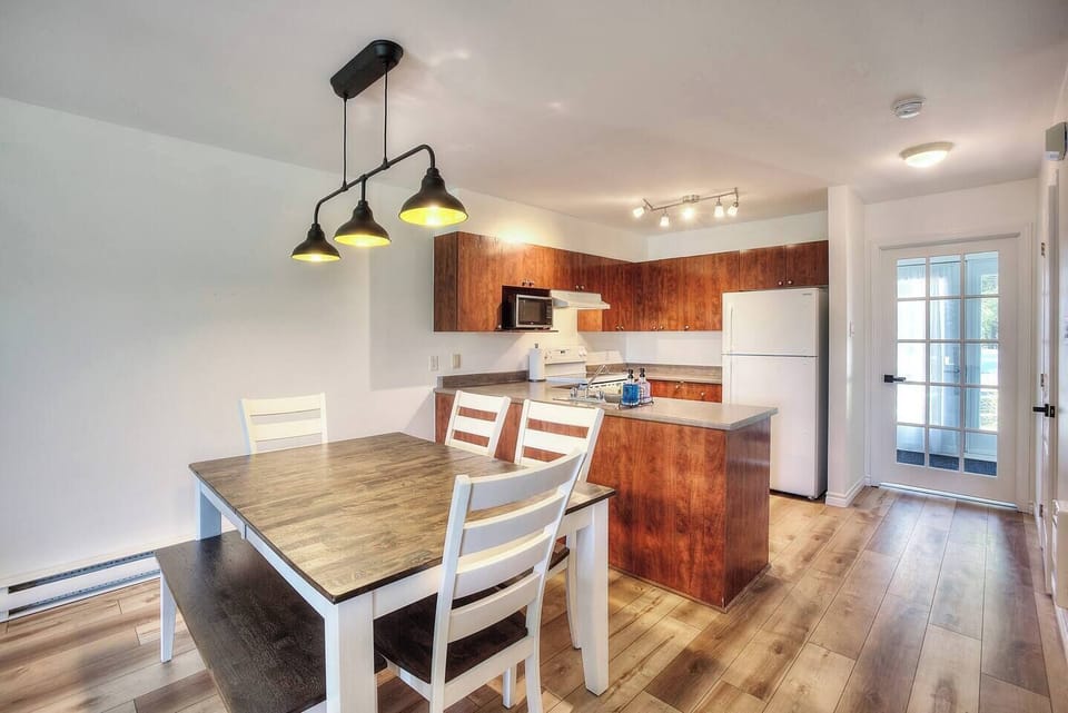 Main dining area and  kitchen right off the living room. Open concept for cooking and enjoying the company of friends. Additional chairs are available in the storage closet if your group has 8 guests. 