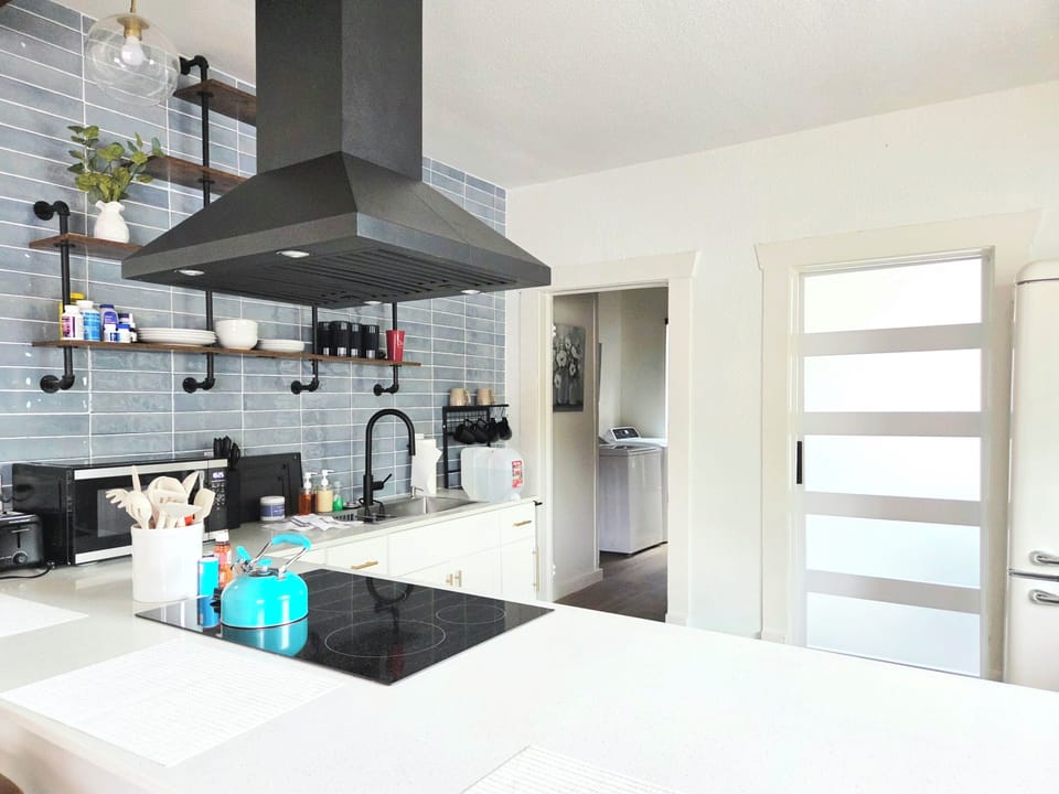 Bright modern kitchen with large island, sleek finishes, and guest-friendly layout