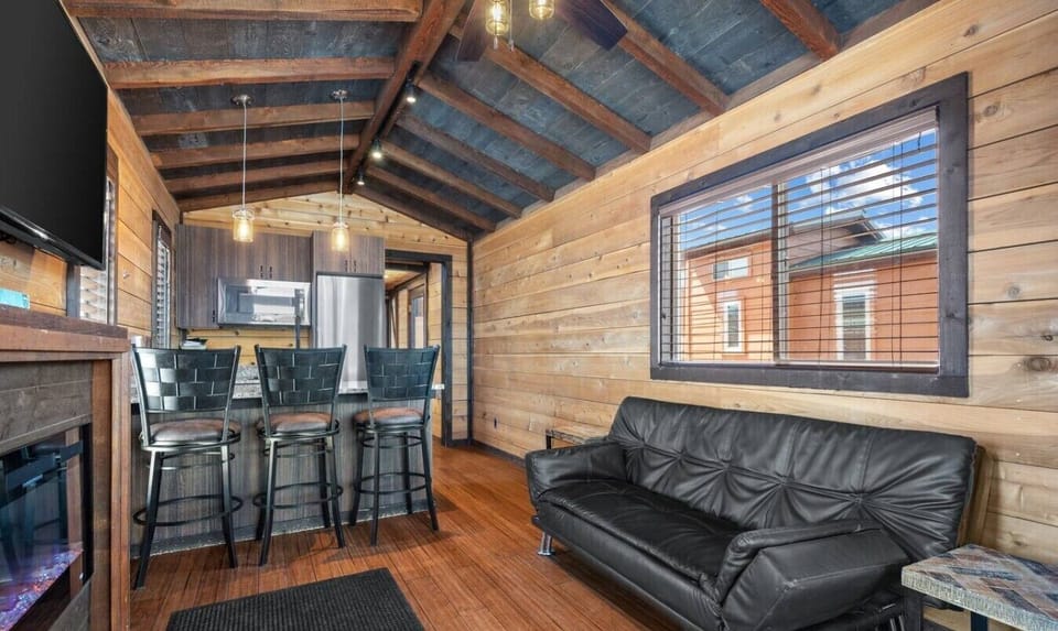 Relax on the sofa in this inviting living space, with a dining area and kitchen conveniently nearby.