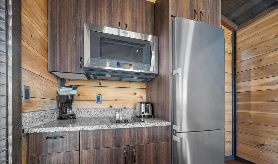 Prepare your favorite meals with the stainless steel refrigerator, microwave, coffee maker, and toaster.