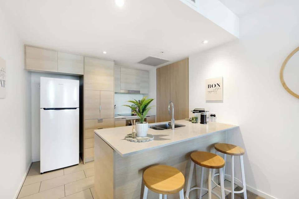 Brew your morning espresso at the island bar and plan your day's adventures in this bright, functional kitchen.