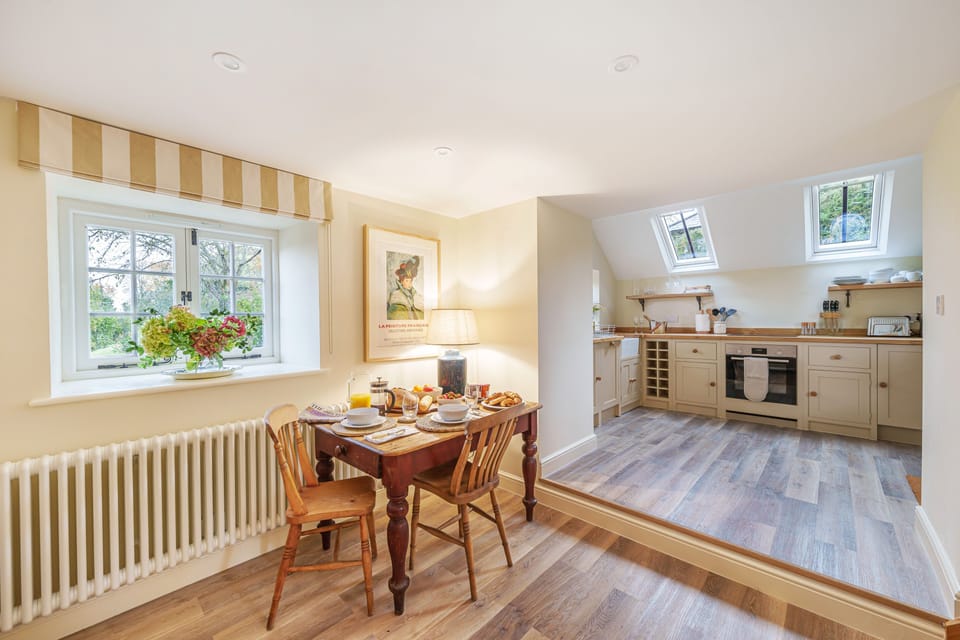 Puddle Cottage, Chebbard, Dorchester: The dining area and step up to the kitchen