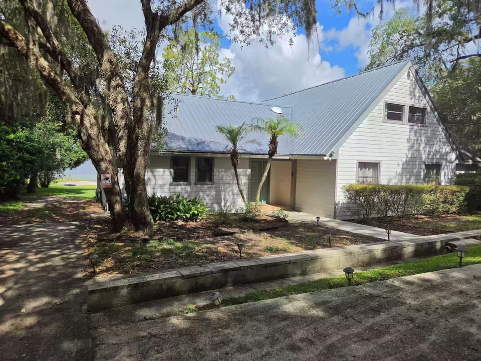 Parking area is in front of the garage with lighted path to front door
