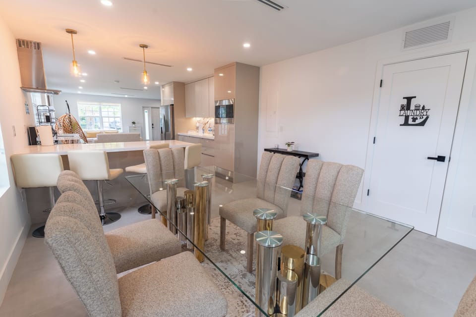 Bright modern kitchen and dining area with island seating and chic finishes