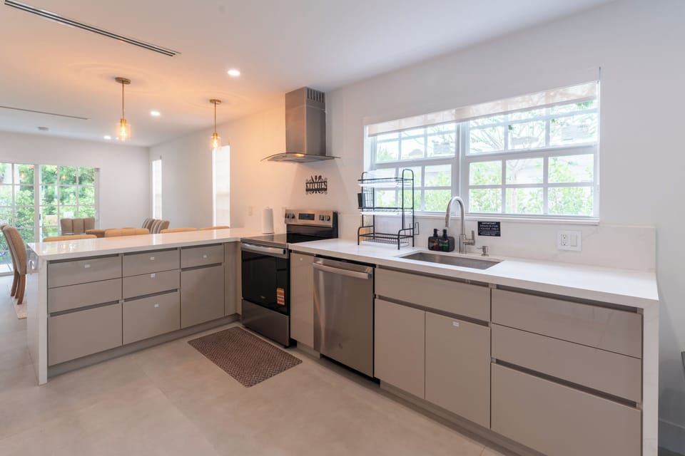 Bright modern kitchen with stainless appliances and spacious peninsula