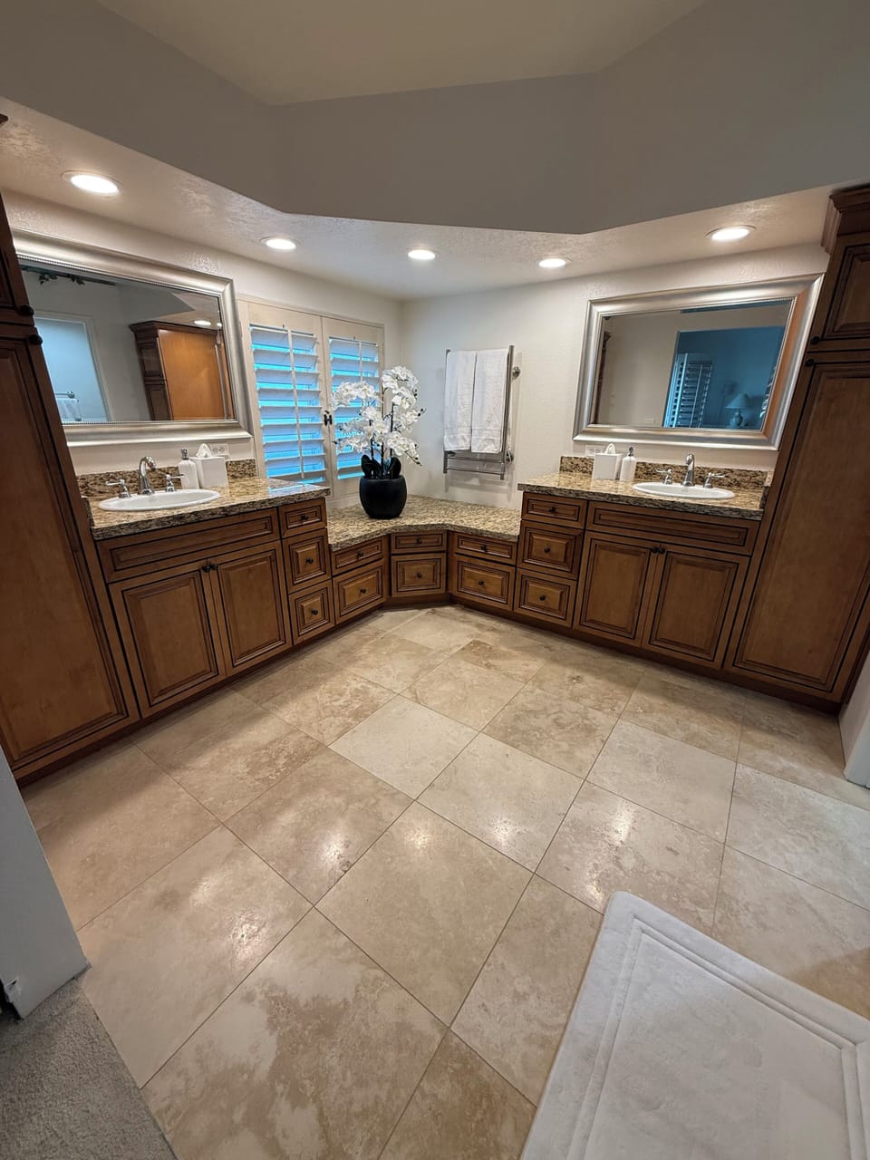 Double vanity, custom cabinets, and towel warmer. 