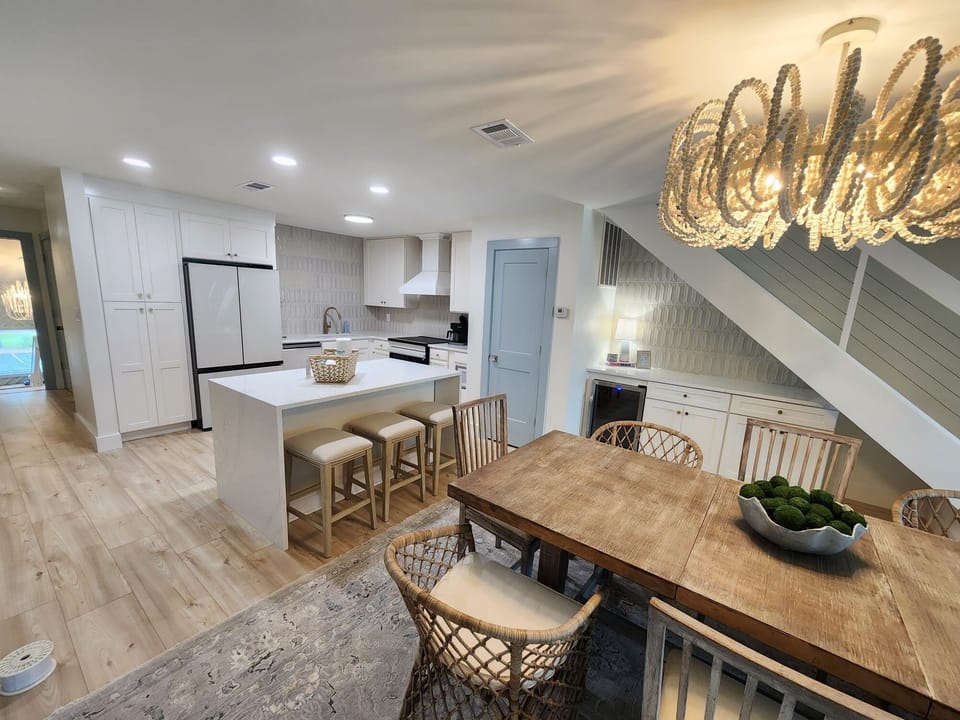 Bright designer kitchen and dining space with island seating. Coffee bar and bar fridge for all your entertaining needs.
