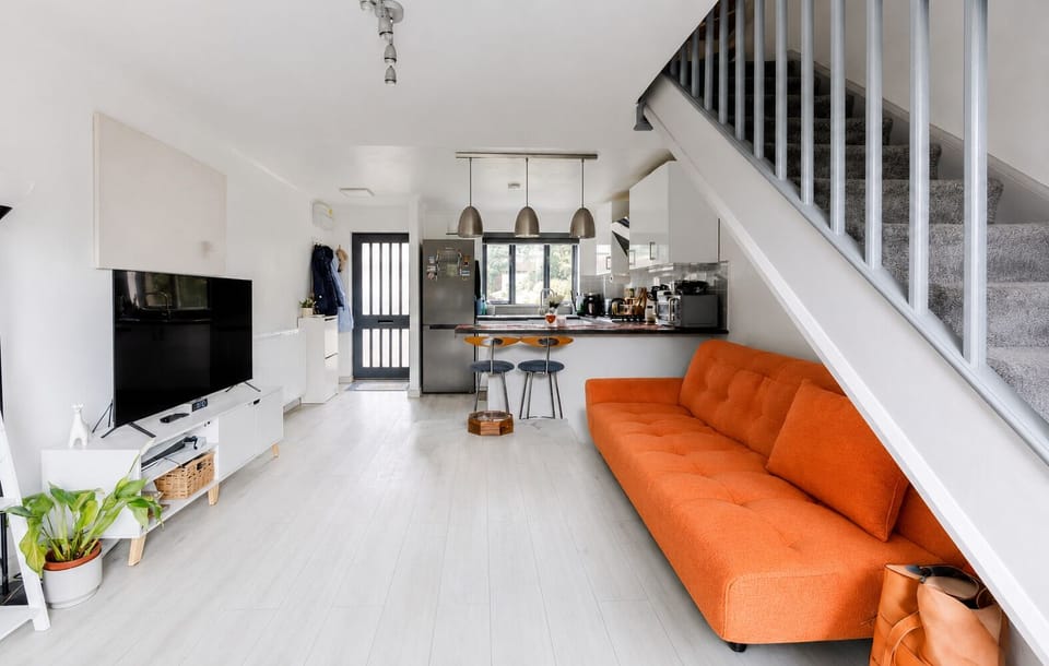The open plan kitchen/living room features a smart TV and a double sofa bed