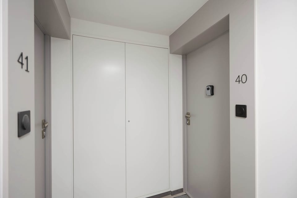 A clean and modern entrance to the apartment. The bright hallway creates a welcoming first impression.