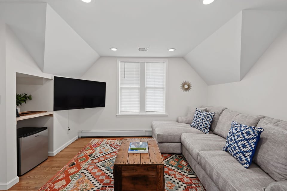 Enjoy a cozy movie night with your family and friends with this third level living room area.