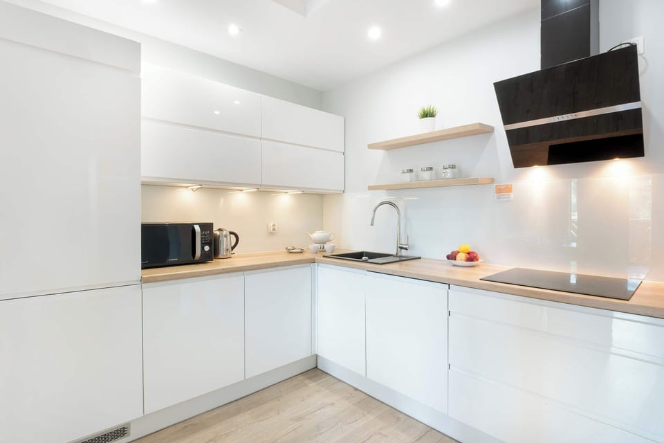 The sleek design of the kitchenette blending seamlessly with the living area.