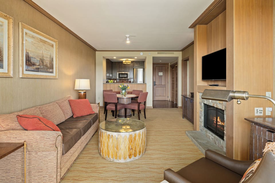 Cozy suite with fireplace, dining area, and convenient kitchenette