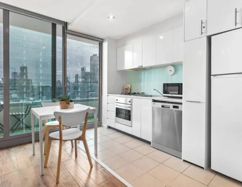 Prepare meals with ease in the compact kitchen featuring an oven, dishwasher, stove and microwave, while a sunny dining corner offers a relaxed space to enjoy them.
