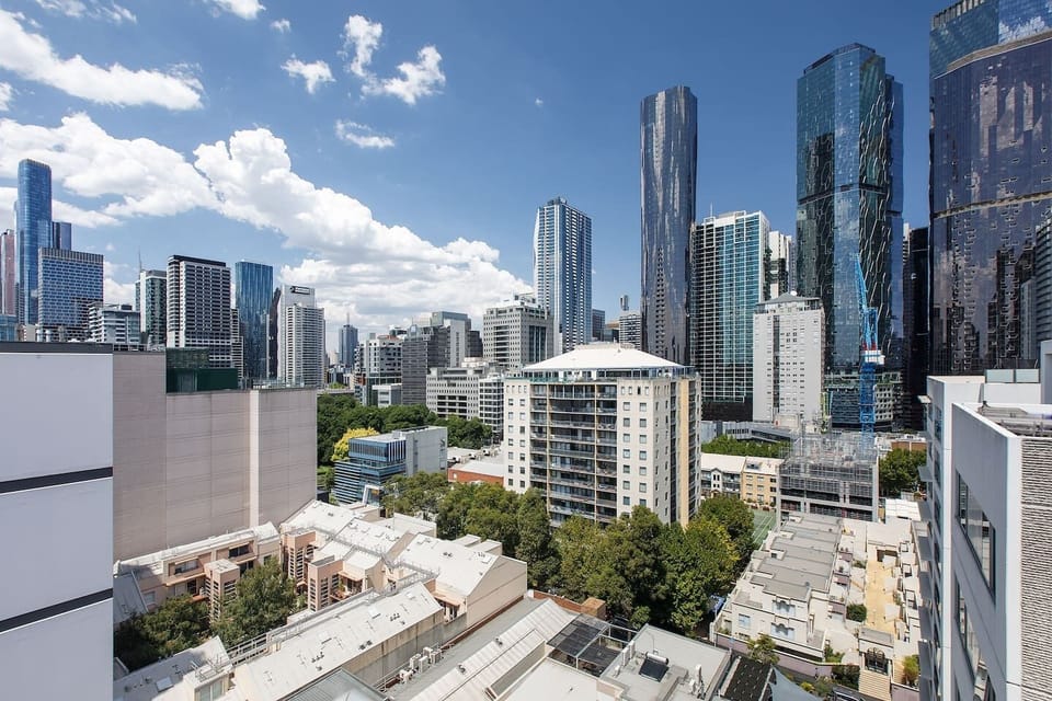 Take in sweeping rooftop views across Melbourne’s cityscape, where the contrast of green canopies and gleaming towers capture the essence of urban living.