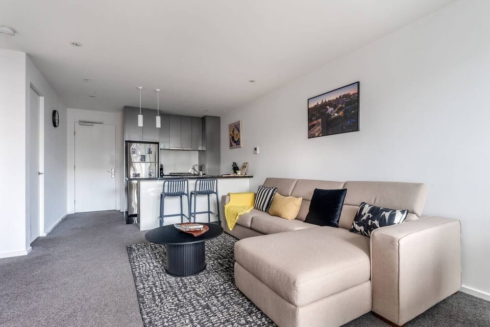 The open-plan design connects the kitchen and living space, creating a seamless environment for preparing meals, dining, and relaxing.
