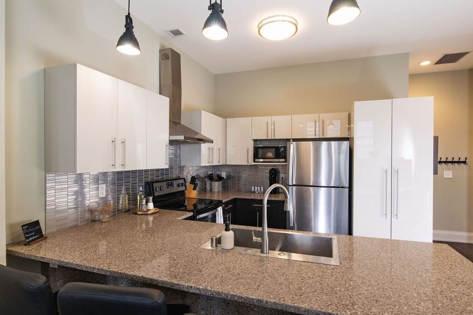 A fully-equipped kitchen featuring high-end finishes and bar seating—everything you need to prep, cook, and refuel