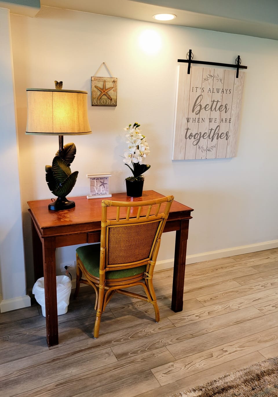 The desk has plenty of light and an outlet with easy access.