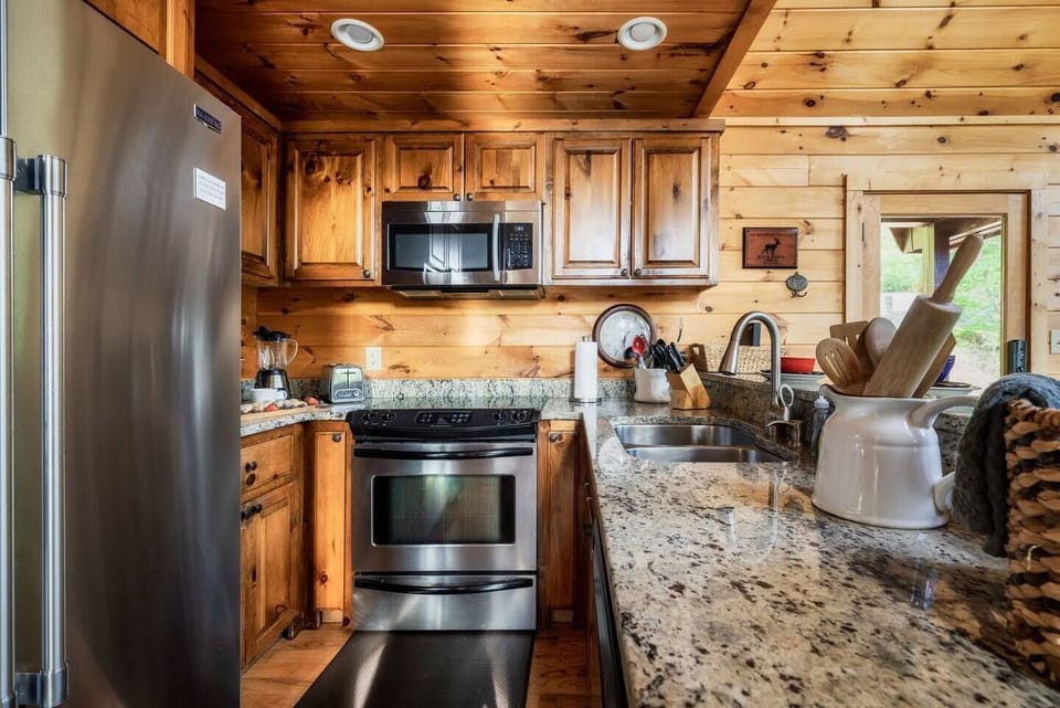 Cabin kitchen with stainless steel like appliances. Well Stocked.
